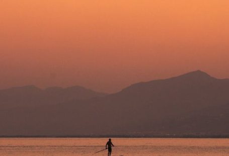Tourist Traps - Tourist Paddleboarding at Sunset