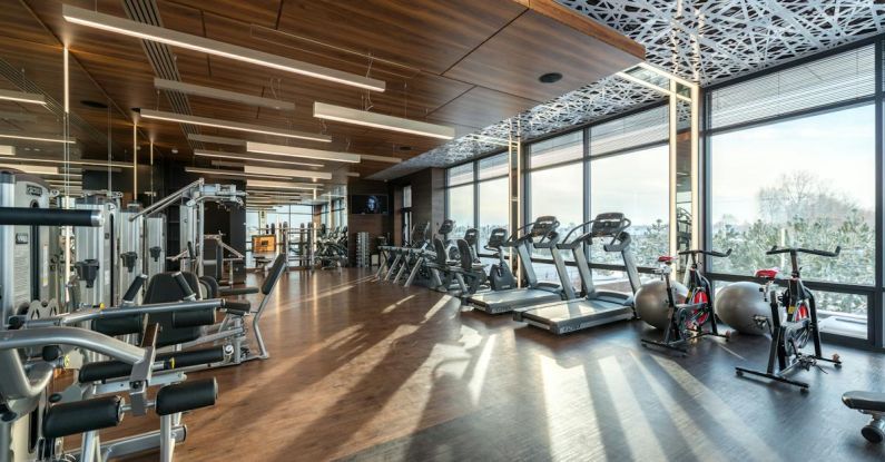 Spas And Wellness Centers - Interior of modern fitness club with various machines and equipment