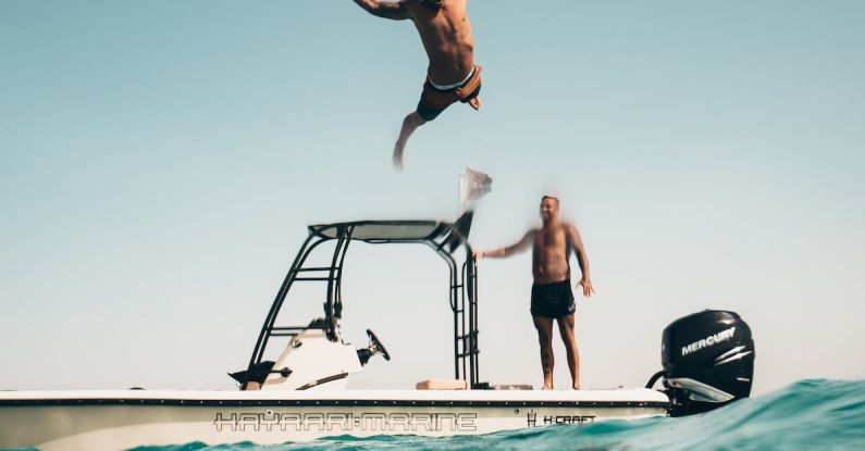 Leisure Cruise - Photo of Man Jumping from Boat to the Sea