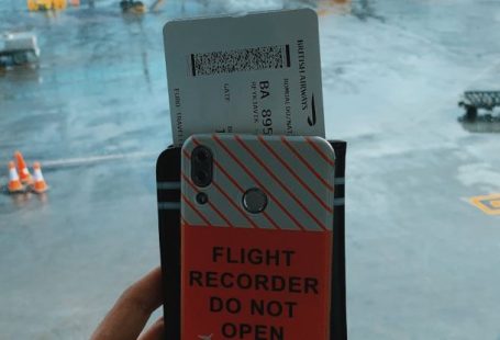 Tourist Travel Pass - Crop traveler with smartphone and boarding pass in airport