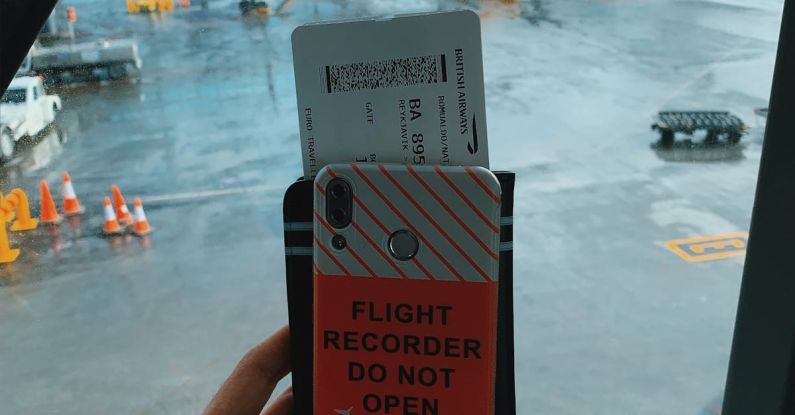 Tourist Travel Pass - Crop traveler with smartphone and boarding pass in airport